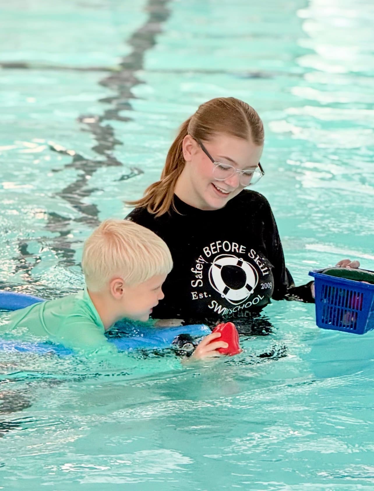 Instructor with child in pool